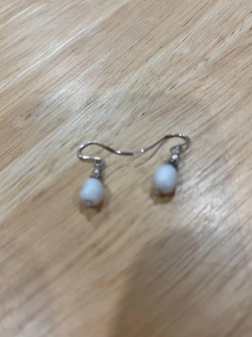 Silver tone and white stone hook back earrings